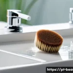 메이크업 소품 관리와 유지 보수 - A detailed close-up of a variety of makeup brushes and sponges being gently cleaned in a bright, cle...